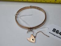 864 · GOLD BANGLE STAMPED 9CT WITH L