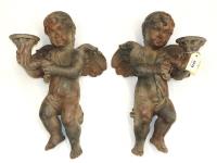 1079 · A PAIR OF WALL MOUNTED PUTTI C